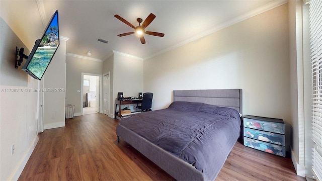 bedroom featuring ceiling fan, ornamental molding, wood-type flooring, and ensuite bath