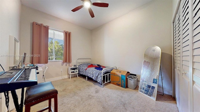 bedroom with ceiling fan and light colored carpet