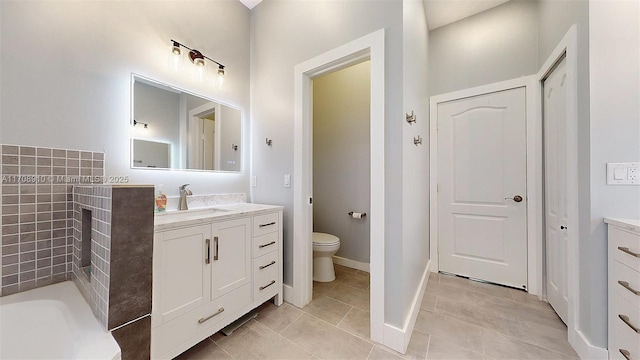 bathroom featuring tile patterned flooring, vanity, and toilet