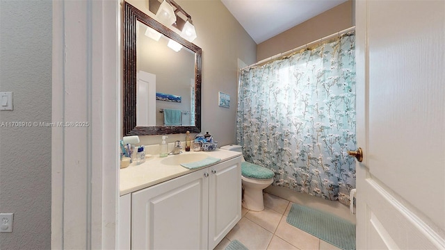 bathroom with tile patterned flooring, vanity, and toilet