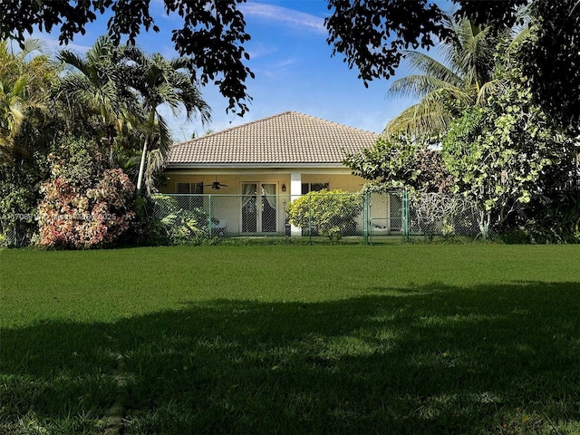 rear view of property featuring a yard