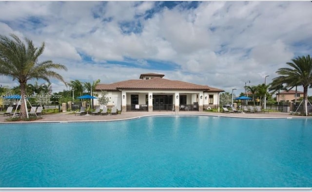 pool featuring a patio area and fence