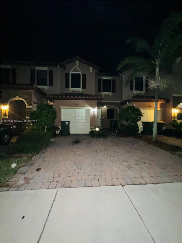 view of front of property with decorative driveway and an attached garage