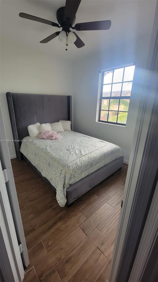 bedroom featuring a ceiling fan and wood finished floors