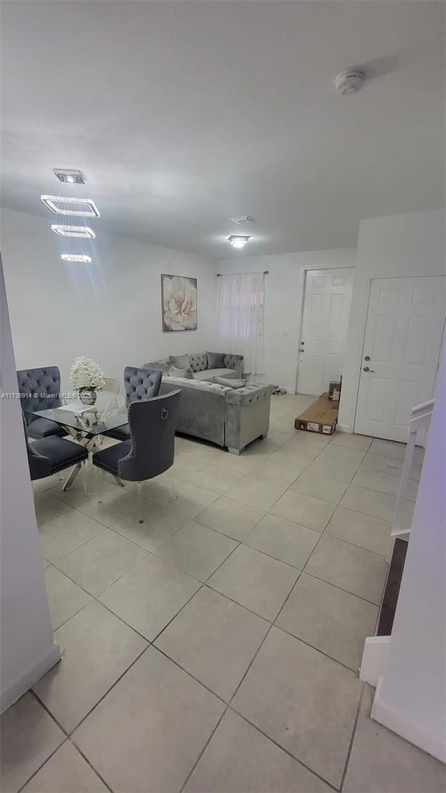 living area with light tile patterned floors and visible vents