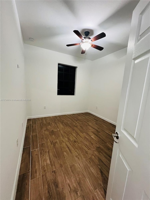 unfurnished room featuring ceiling fan, wood finished floors, and baseboards