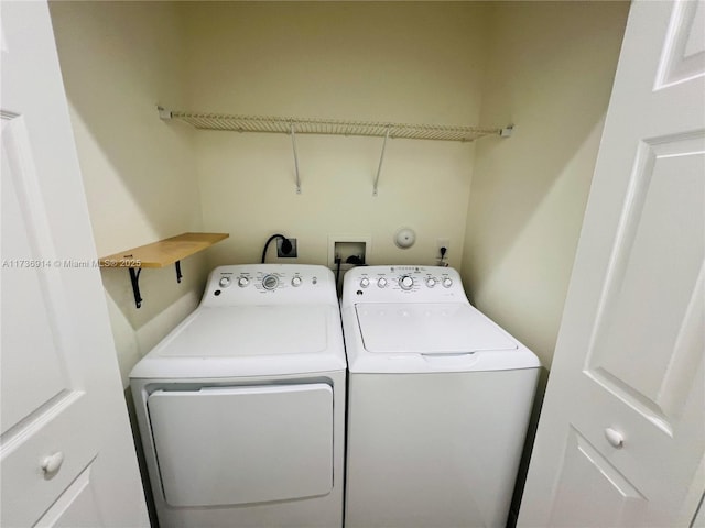 washroom featuring laundry area and separate washer and dryer