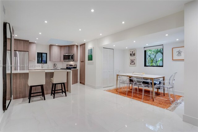 kitchen featuring appliances with stainless steel finishes and a breakfast bar area