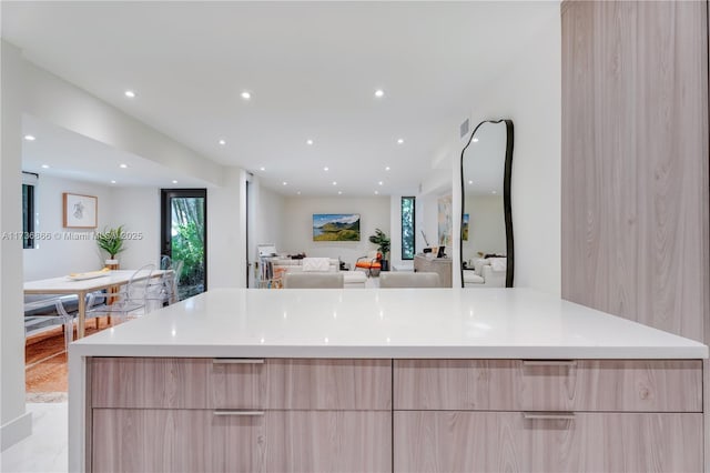 kitchen with a large island and light brown cabinets