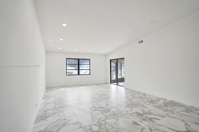 empty room with marble finish floor, visible vents, baseboards, and recessed lighting