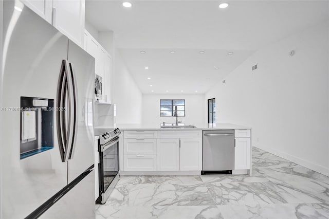 kitchen featuring white cabinetry, appliances with stainless steel finishes, and light countertops