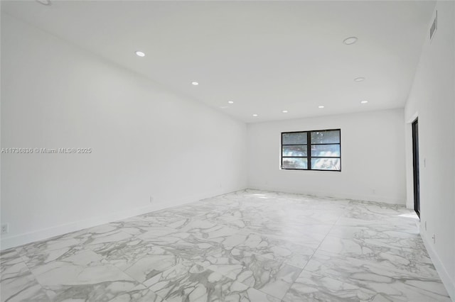 spare room with recessed lighting, marble finish floor, visible vents, and baseboards