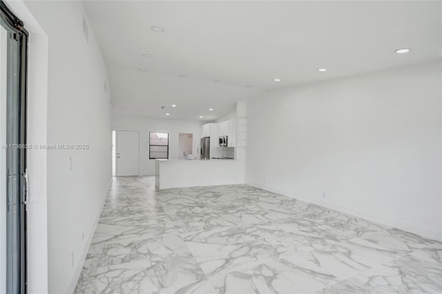 unfurnished living room with marble finish floor, baseboards, vaulted ceiling, and recessed lighting