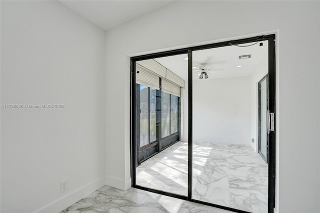 empty room featuring marble finish floor, visible vents, baseboards, and ceiling fan