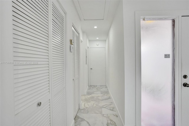 hall featuring marble finish floor, recessed lighting, and baseboards