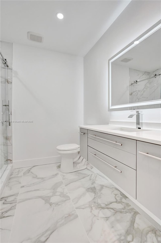 bathroom with toilet, recessed lighting, vanity, marble finish floor, and a marble finish shower