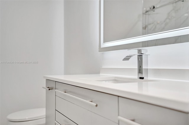 bathroom featuring toilet and vanity