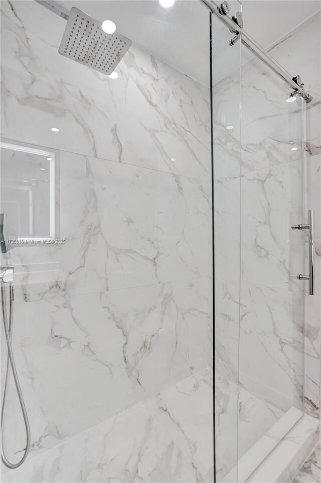 full bathroom featuring a marble finish shower