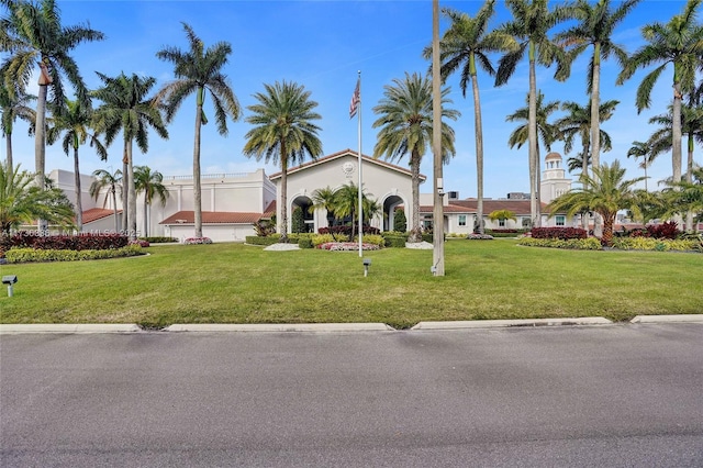 mediterranean / spanish-style house with a front yard