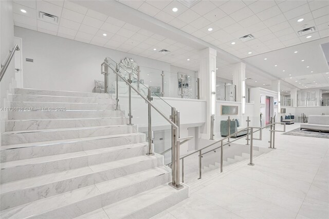 stairway featuring visible vents and recessed lighting