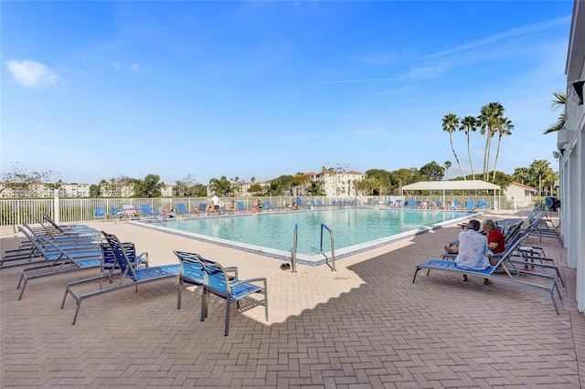 pool featuring a patio and fence