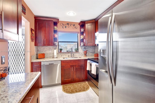 kitchen with stainless steel appliances, light stone countertops, sink, and backsplash