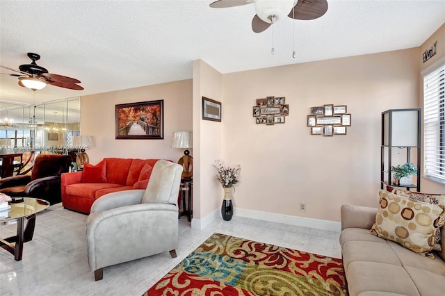 living room featuring a textured ceiling and ceiling fan