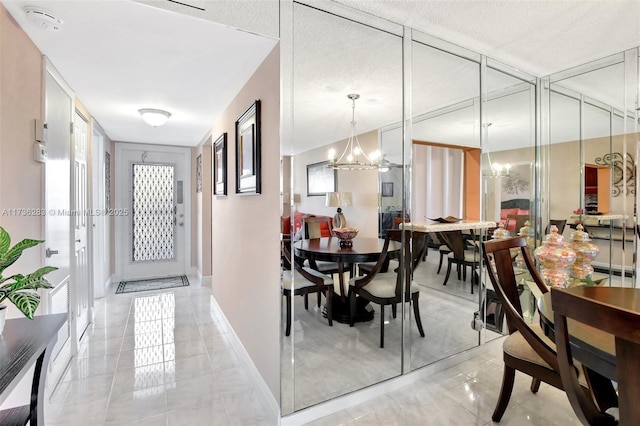 dining room featuring an inviting chandelier and a textured ceiling