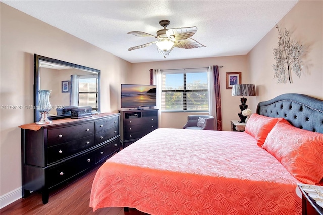 bedroom featuring multiple windows, hardwood / wood-style floors, and a textured ceiling