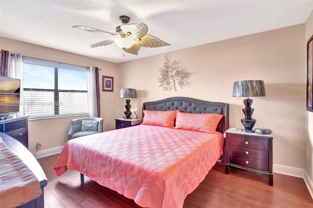 bedroom featuring ceiling fan, dark wood-type flooring, and a textured ceiling