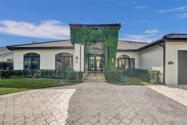 view of front facade featuring a garage and french doors