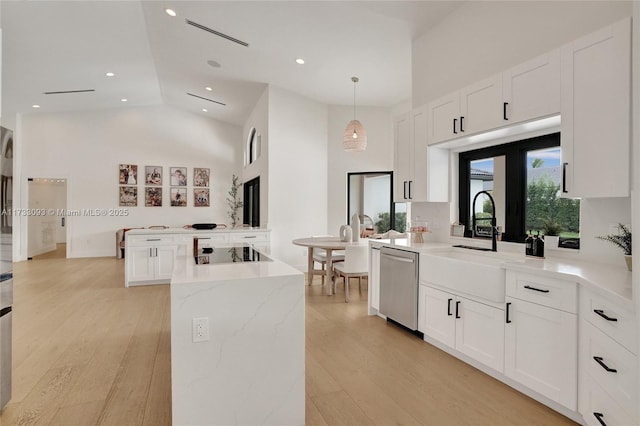 kitchen featuring black electric stovetop, dishwasher, hanging light fixtures, and white cabinets