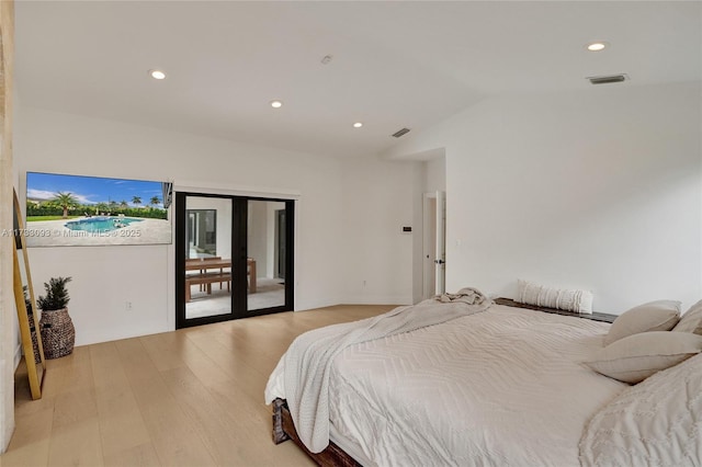 bedroom with lofted ceiling, access to exterior, light hardwood / wood-style floors, and french doors