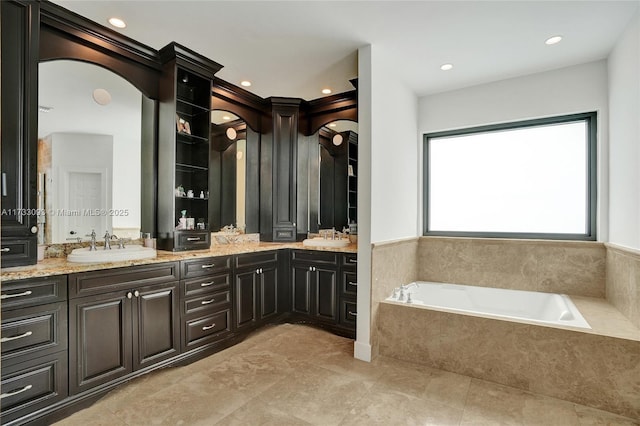 bathroom featuring vanity, tiled bath, and tile patterned floors