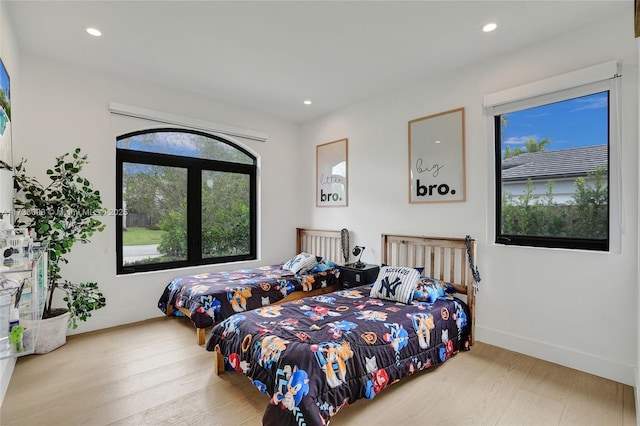 bedroom featuring multiple windows and light wood-type flooring