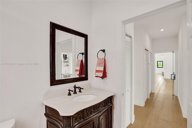 bathroom featuring vanity and wood-type flooring