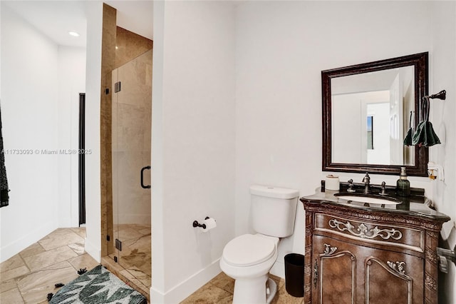 bathroom with toilet, vanity, and walk in shower