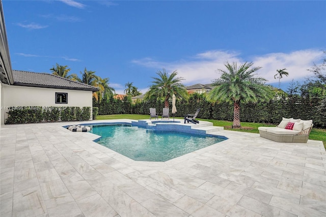 view of pool featuring a patio and an in ground hot tub