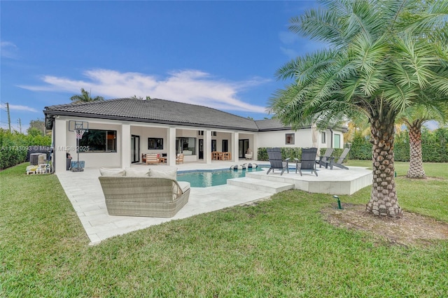 rear view of property with a patio, outdoor lounge area, a yard, and central AC unit