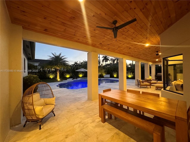 exterior space featuring outdoor lounge area, pool water feature, and ceiling fan