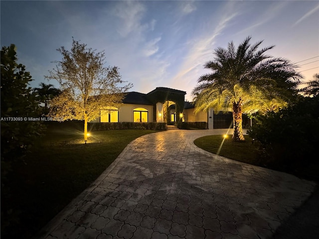 mediterranean / spanish home featuring a garage