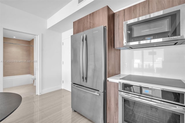 kitchen with stainless steel appliances and light tile patterned floors