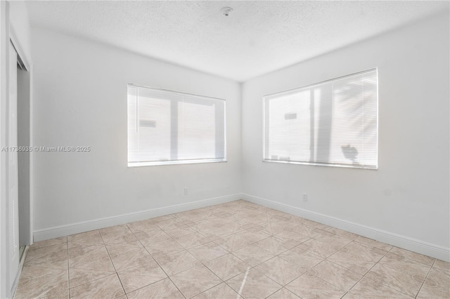 spare room with a textured ceiling