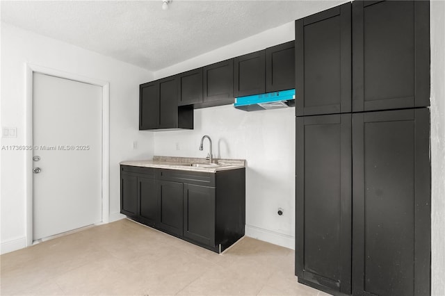 kitchen featuring sink and a textured ceiling