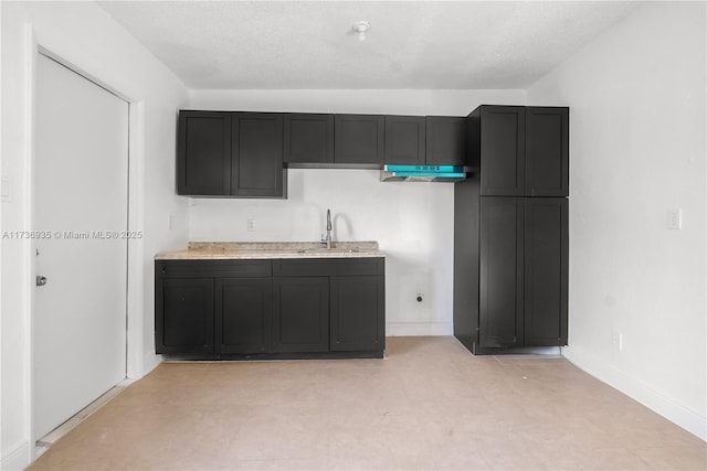 kitchen featuring sink and a textured ceiling