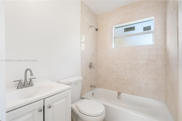 full bathroom with vanity, toilet, and tiled shower / bath