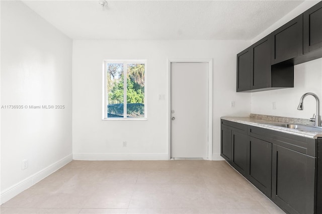 kitchen featuring sink and a textured ceiling