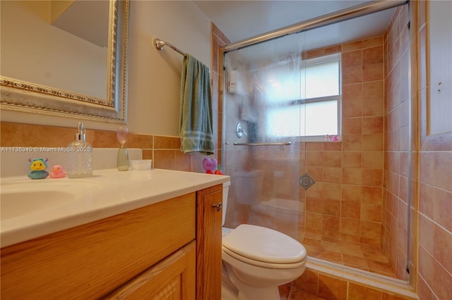 bathroom with vanity, toilet, and an enclosed shower