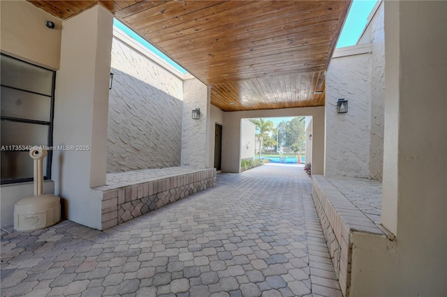 corridor with carpet and wooden ceiling