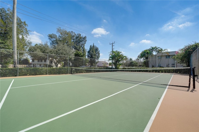 view of tennis court with basketball hoop